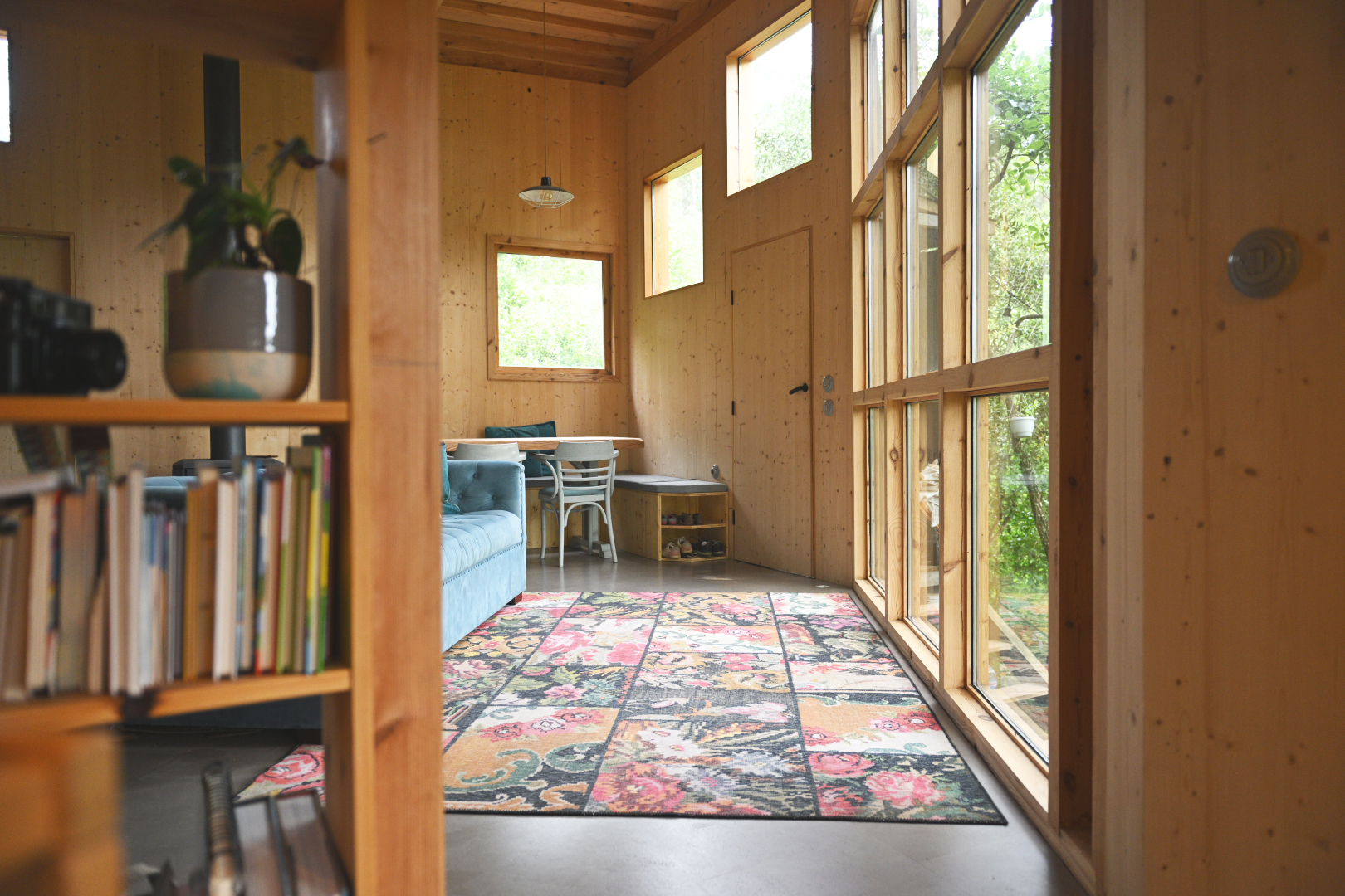 Dining nook seen past a timber bookshelf